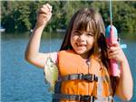 A little girl holding a fish she has caught at ALLATOONA LANDING MARINE RESORT - thumbnail