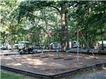 The playground area with swings at DRUMMER BOY CAMPING RESORT - thumbnail