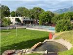 Overlooking the pool and a grassy area at MOUNTAIN SHADOWS RV PARK & MHP - thumbnail