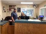 A man and lady at the registration desk at ROCKY MOUNTAIN 'HI' RV PARK AND CAMPGROUND - thumbnail