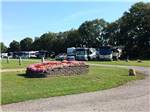 Winding road and flower bed near RVs at ELKHART CAMPGROUND - thumbnail