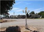 A row of travel trailers parked in gravel sites at CARLSBAD RV PARK & CAMPGROUND - thumbnail
