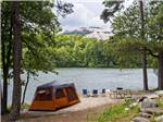 A tent set up along the water at STONE MOUNTAIN PARK CAMPGROUND - thumbnail