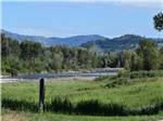 A green field by the river at RIVERBEND RV PARK OF TWISP - thumbnail
