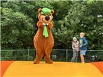 Yogi Bear and two kids on the jumping pillow at JELLYSTONE PARK ™ AT BIRCHWOOD ACRES - thumbnail