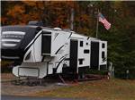 A fifth wheel trailer parked in a RV site at JELLYSTONE PARK ™ AT BIRCHWOOD ACRES - thumbnail