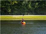 A young boy kayaking in the lake at JELLYSTONE PARK ™ AT BIRCHWOOD ACRES - thumbnail