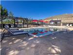 The swimming pool with lounge chairs at COMSTOCK COUNTRY RV RESORT - thumbnail