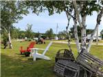Two Adirondack chairs in a grassy area at BRAS D'OR LAKES CAMPGROUND ON THE CABOT TRAIL - thumbnail