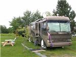 RV and picnic table at BRAS D'OR LAKES CAMPGROUND ON THE CABOT TRAIL - thumbnail