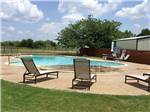 Splash pad and pool with lounge chairs at DALLAS NE CAMPGROUND - thumbnail
