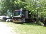 A motorhome in a back in RV site at CAMP TOODIK FAMILY CAMPGROUND, CABINS & CANOE LIVERY - thumbnail