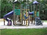 Kids playing on the playground equipment at ACORN CAMPGROUND - thumbnail