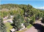 Aerial view over campground, trees and mountainside at PAGOSA RIVERSIDE CAMPGROUND - thumbnail