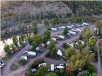 Aerial view of motorhomes and mountainside at PAGOSA RIVERSIDE CAMPGROUND - thumbnail