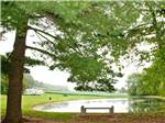 Lake with motorhome and green trees at SPRING GULCH RESORT CAMPGROUND - thumbnail