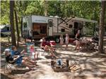 Family gathered around travel trailer in campsite at OCEAN VIEW RESORT CAMPGROUND - thumbnail