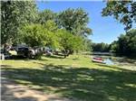 A group of grassy RV sites by the water at LANSING COTTONWOOD CAMPGROUND - thumbnail