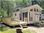A park model with a large deck at BARABOO RV RESORT BY RJOURNEY - thumbnail