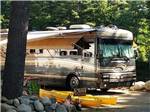 A motorhome with kayaks sitting in front at LAKE GEORGE RIVERVIEW CAMPGROUND - thumbnail