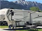 A Montana fifth wheel in a deluxe pull thru site at SUN OUTDOORS YELLOWSTONE NORTH - thumbnail