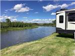 Grassy RV sites next to the river at DEER LODGE A-OK CAMPGROUND - thumbnail