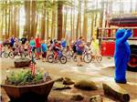 Group of kids on bikes with a fire truck at WASSAMKI SPRINGS CAMPGROUND - thumbnail