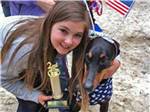 Girl proud of her second-place dog at ATLANTIC SHORE PINES CAMPGROUND - thumbnail