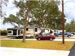 Travel trailers and cars in paved sites at I-10 KAMPGROUND - thumbnail