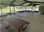 Picnic benches under the pavilion at STAGE STOP CAMPGROUND - thumbnail