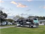 A motorhome in a grassy RV site at STAGE STOP CAMPGROUND - thumbnail