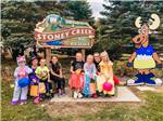 A group of kids around the front entrance sign at STONEY CREEK RV RESORT - thumbnail