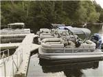 Pontoon boats at the dock at HARMONY LAKESIDE RV PARK & DELUXE CABINS - thumbnail