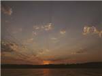 Looking at the lake at dusk at HARMONY LAKESIDE RV PARK & DELUXE CABINS - thumbnail