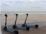 A row of rental scooters by the beach nearby at PADRE PALMS RV PARK - thumbnail