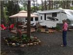A person admiring her well-manicured campsite at CHRISTOPHER RUN CAMPGROUND - thumbnail