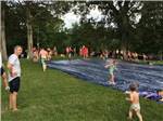 Kids playing on a slip-and-slide at CHRISTOPHER RUN CAMPGROUND - thumbnail