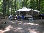 People hanging out near their pop-up camper at CHRISTOPHER RUN CAMPGROUND - thumbnail