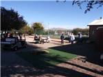 People standing around the corn hole court at SAN PEDRO RESORT COMMUNITY - thumbnail