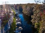 Channel with several boats moored along the banks at HOLIDAY RV VILLAGE - thumbnail