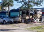 A truck parked in front of a motorhome in a RV site at CAMPER'S INN - thumbnail
