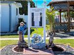 The bulletin board with statues on either side at TAMIAMI RV PARK - thumbnail