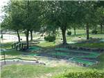 Mini golf course with trees at ROUND TOP CAMPGROUND - thumbnail
