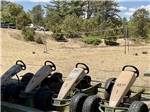 A row of pedal cars and the volleyball court at CAPE COD'S MAPLE PARK CAMPGROUND & RV PARK - thumbnail