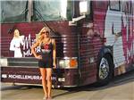 Michelle Murray posing by her bus at SUNDERMEIER RV PARK - thumbnail