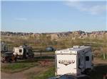 RVs parked near mountains at BADLANDS MOTEL & CAMPGROUND - thumbnail
