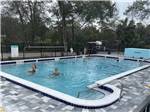 Guest enjoying the swimming pool at LUNA SANDS RV RESORT - thumbnail
