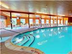 The indoor pool with chairs on the outside at OTTER LAKE CAMP RESORT - thumbnail