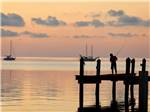 Boy fishing on the pier at JOLLY ROGER RV RESORT - thumbnail