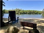 An oversized wooden chair overlooking the water at PINE ACRES FAMILY CAMPING RESORT - thumbnail